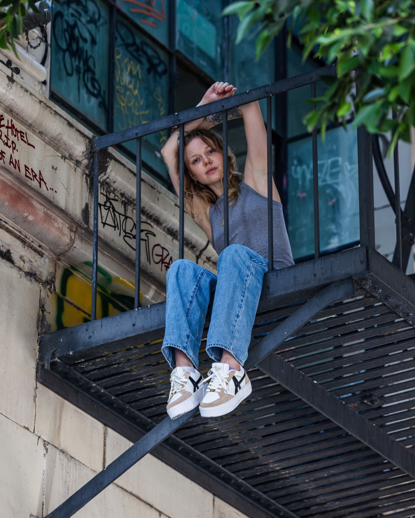 Model seated on a fire escape
