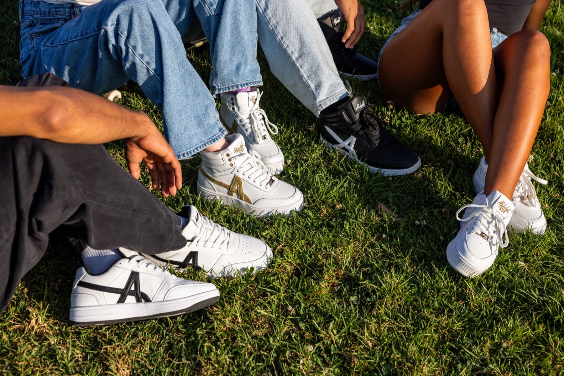 Friends wearing sneakers on the grass